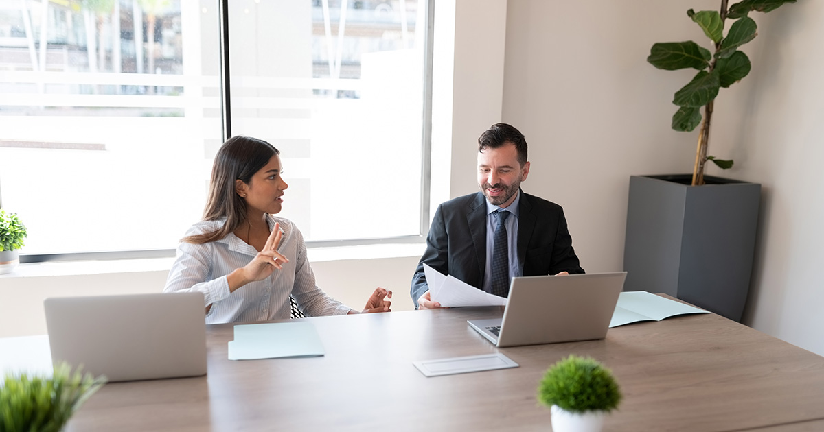 Two business people sitting on office conference room and discussing work.