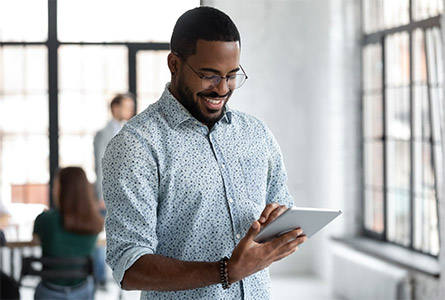 smiling man using a tablet