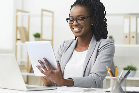 smiling woman looking at tablet