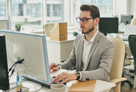 man using computer at desk