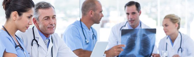 Healthcare workers reviewing patient x-rays