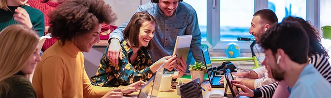 Young professionals laughing during a meeting.