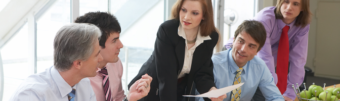 five businesspeople are discussing something in a meeting