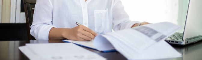 businesswomen checking document and using notebook working