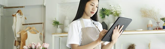 A person uses a large tablet device.