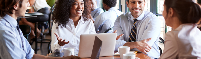 Business Team Having Informal Meeting Around Table In Coffee Shop