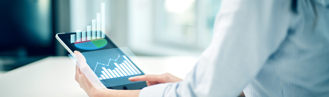 close up of woman with tablet showing growth charts at office