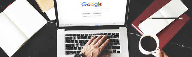 Young Man Browsing Google Website on Laptop