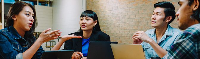 A group of business professionals having a discussion at a table.