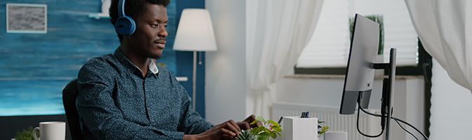 Employee working remotely at a desk in a home office.