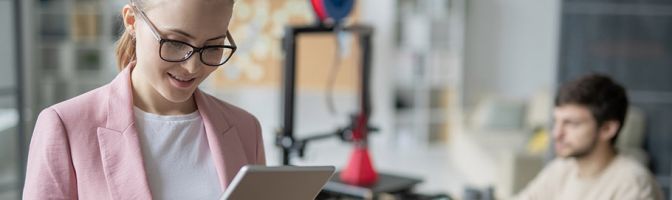 woman looking at tablet while in the office