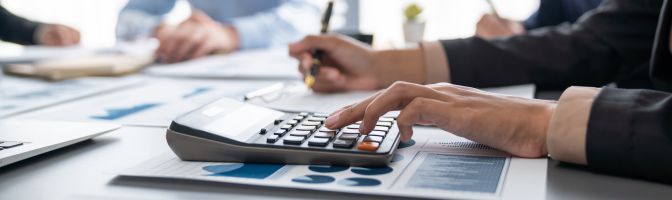 business woman using calculator and pen