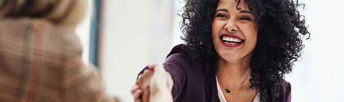 two women shaking hands