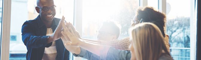 group of people high-fiving each other