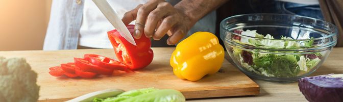 person slicing bell peppers