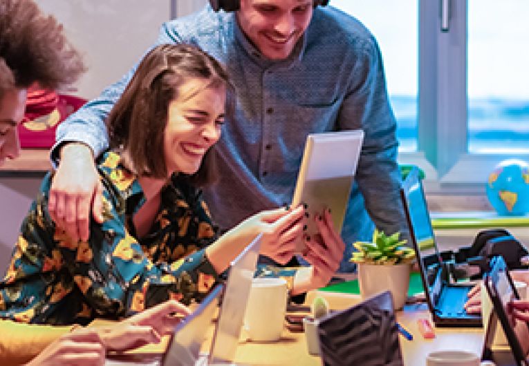 Young professionals laughing during a meeting.