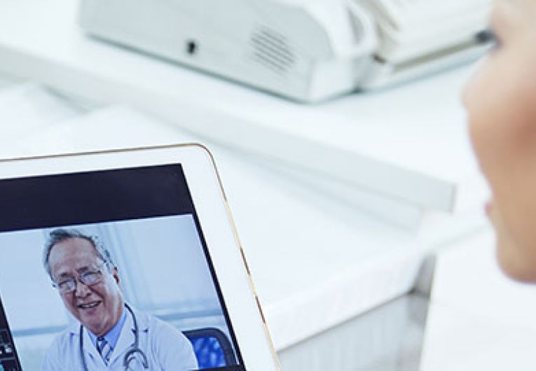 doctor using tablet to talk to another doctor