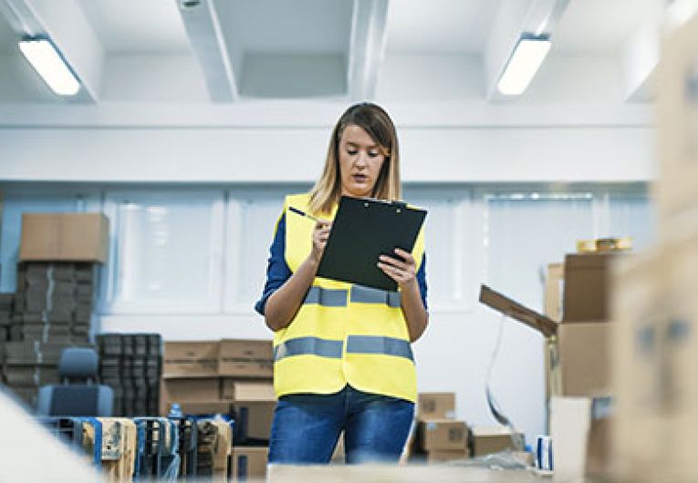 woman taking inventory in a warehouse