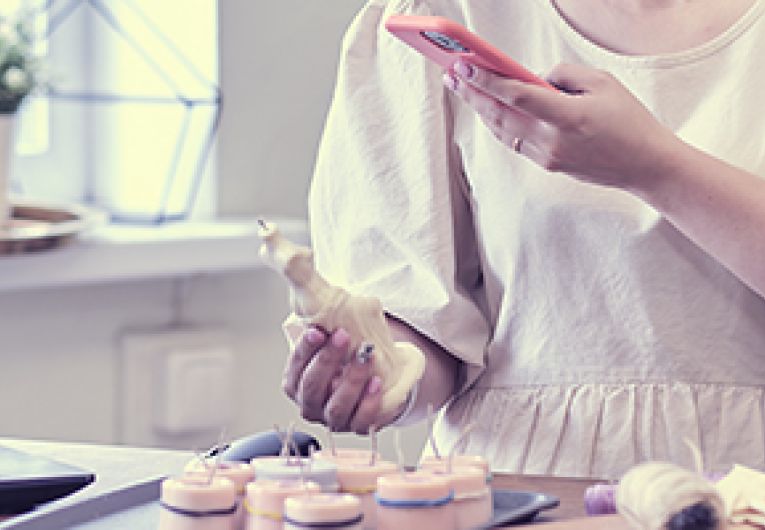 Entrepreneur takes a photo of product to post on social media.