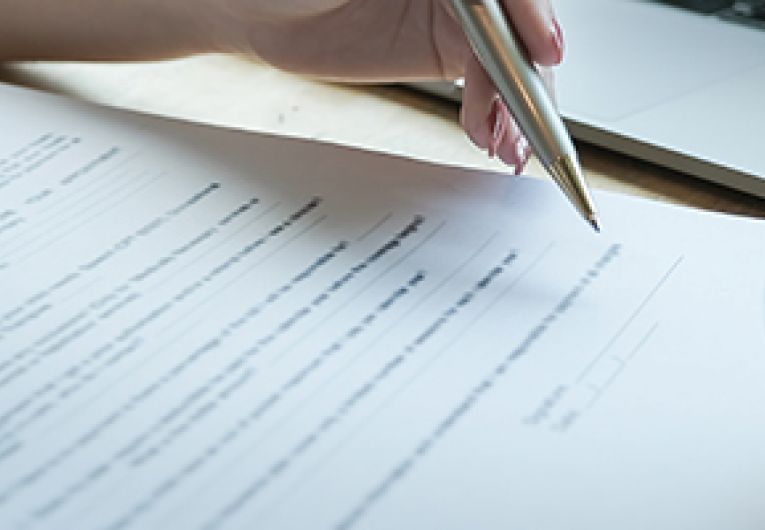 Two business professionals going over an agreement document.