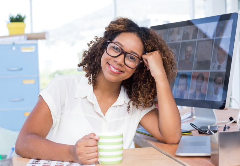 Portrait of smiling female executive holding a cup of coffee in office