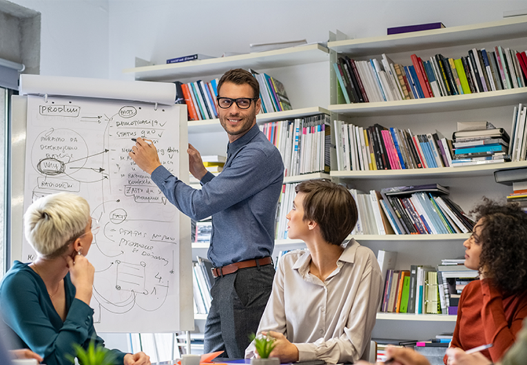 Leader briefing his creative business team with annual goals.