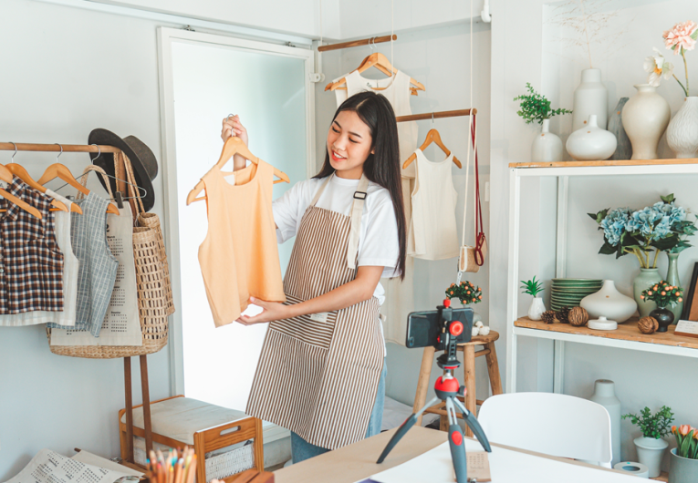 Small business boutique owner displaying summer clothing line