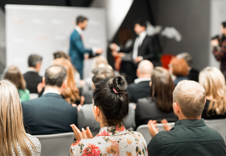 Business team leader receiving award prize at business award ceremony event.