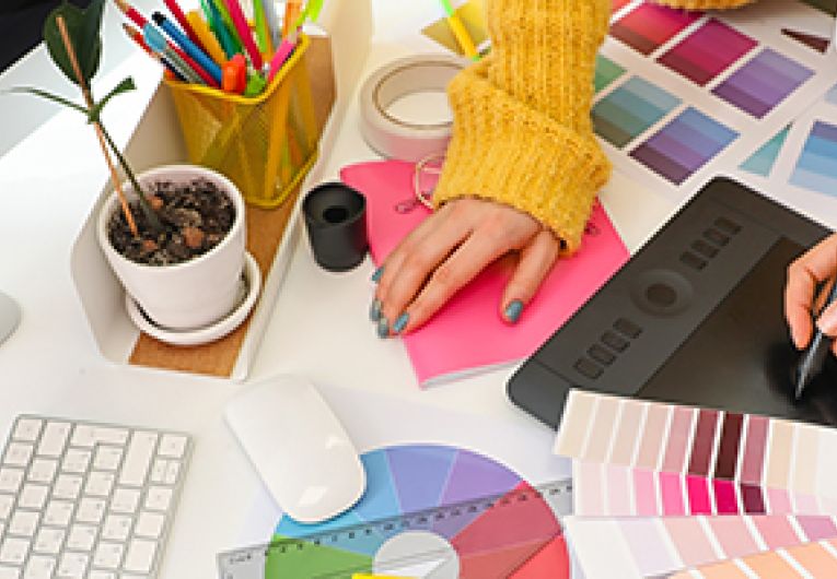 A small business owner discusses branding strategies with graphic designer.
