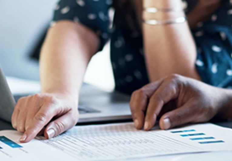 Closeup of two business partners going over financial statements.