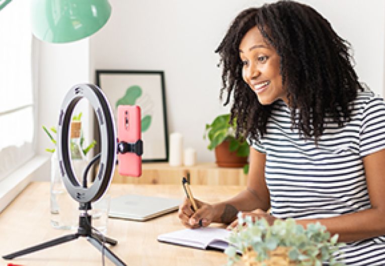 A person recording a video for social media.