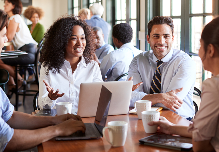 Business Team Having Informal Meeting Around Table In Coffee Shop