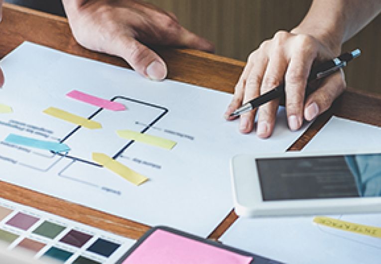 Developers go over designs for mobile app.