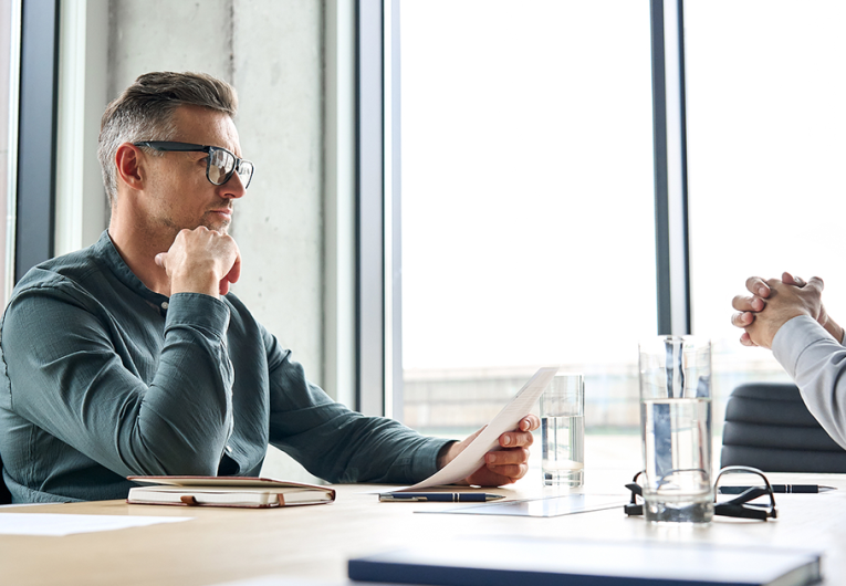 Two, serious, focused, mature businessmen having negotiations at office meeting.