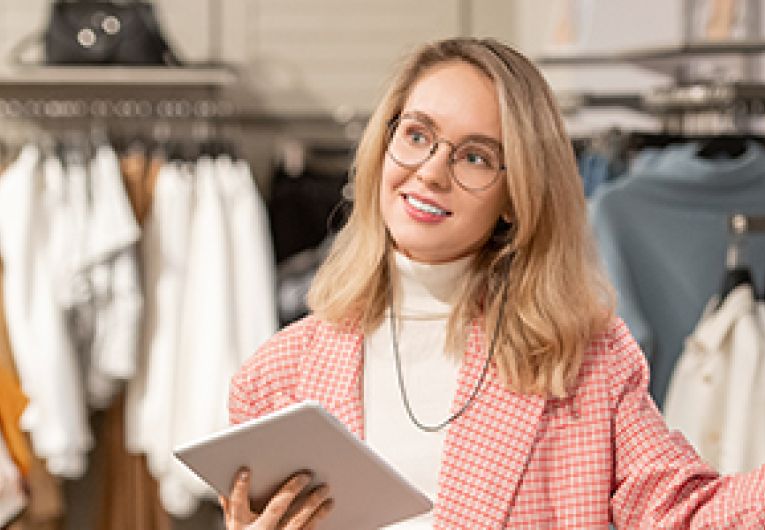 A retail employee talks to a person who is shopping in the store.