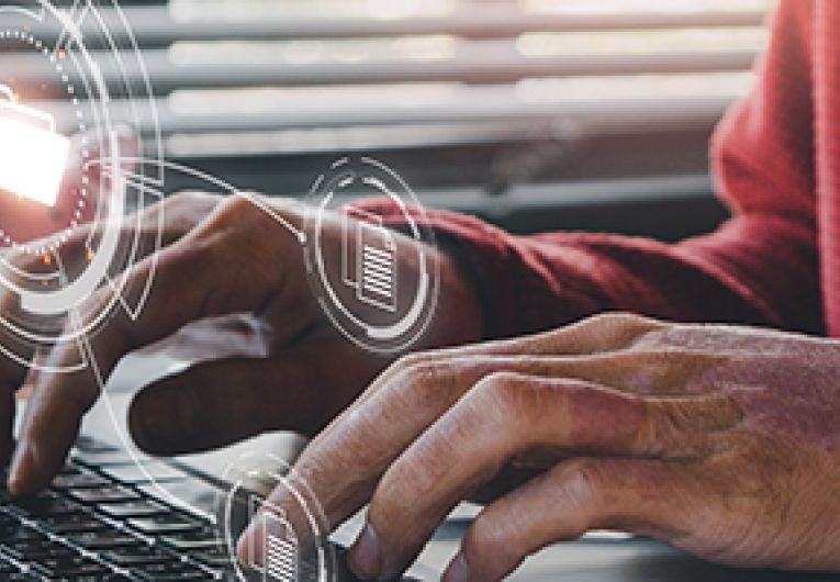 A small business professional manages data on a laptop.