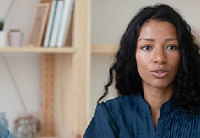 Small Business Owner has a discussion with her employees.