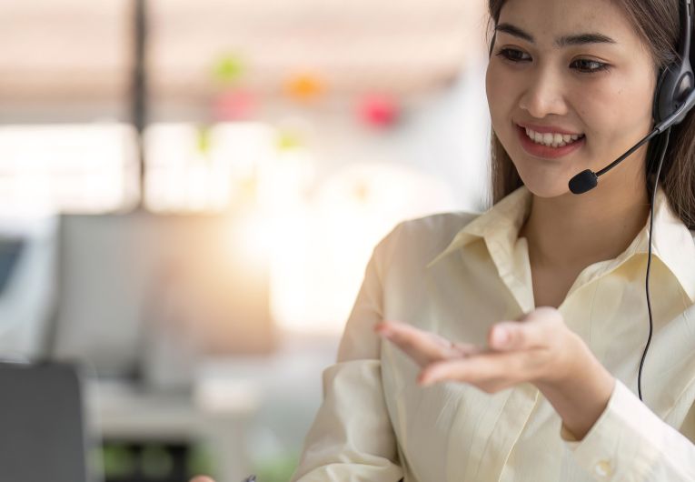 business woman on computer with headset
