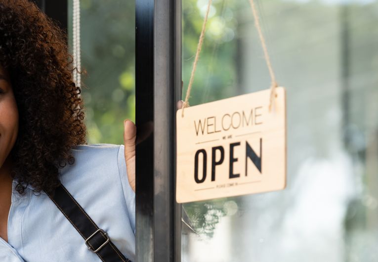 friendly business owner opening shop