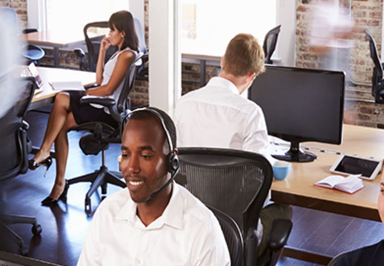 Office workers at their desks on the phone