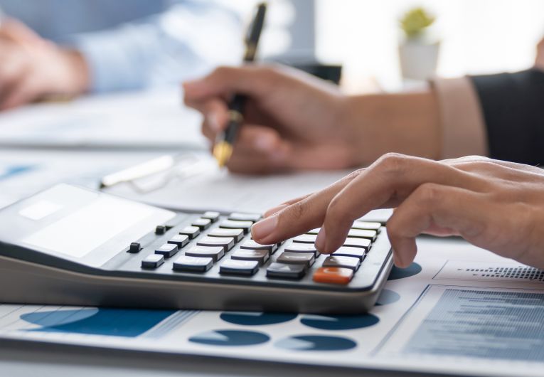 business woman using calculator and pen