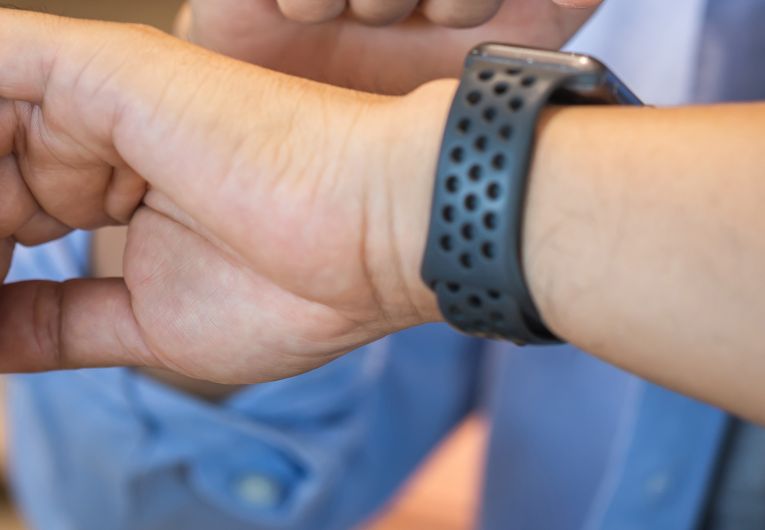 man checking smart watch with blue dress shirt on