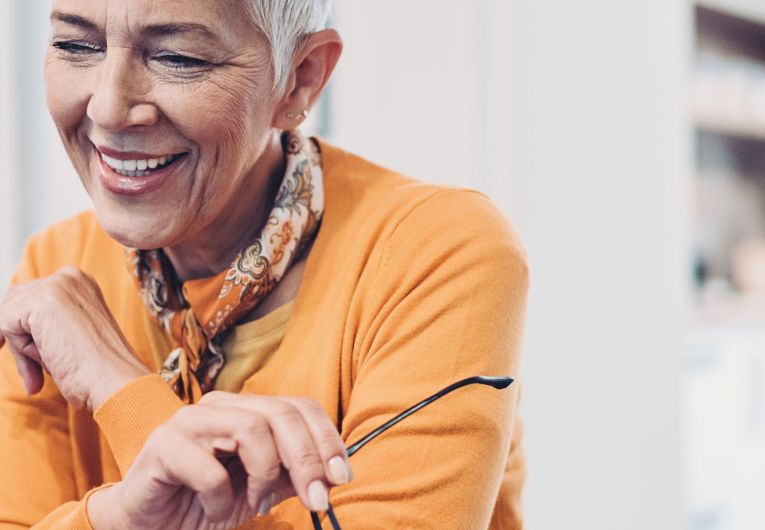 senior woman smiling at laptop