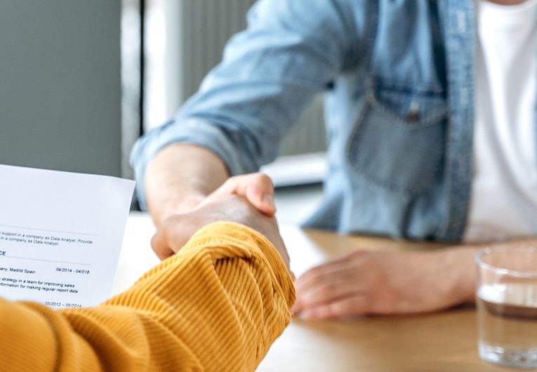 two men shake hands at casual office