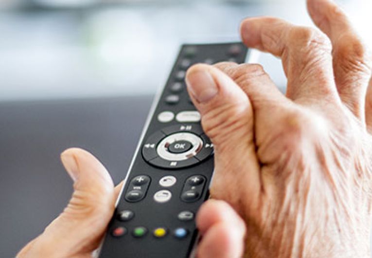 close up of a person using a tv remote
