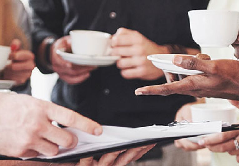 people discussing work while having coffee