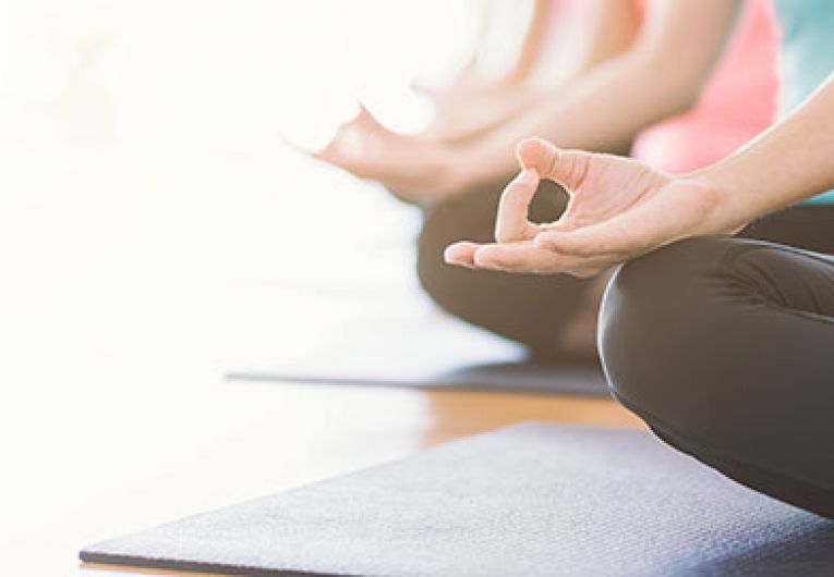 close up of women doing yoga