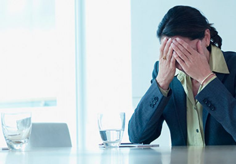 exhausted woman alone in conference room