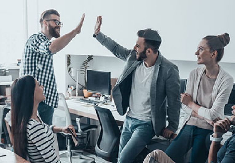 office team giving high fives