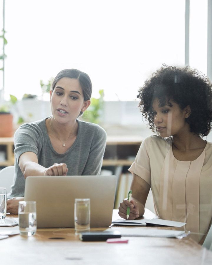 two women looking at a laptop